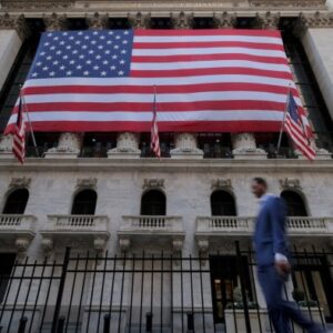 A large US flag hangs on the facade of the New York Stock Exchange building.